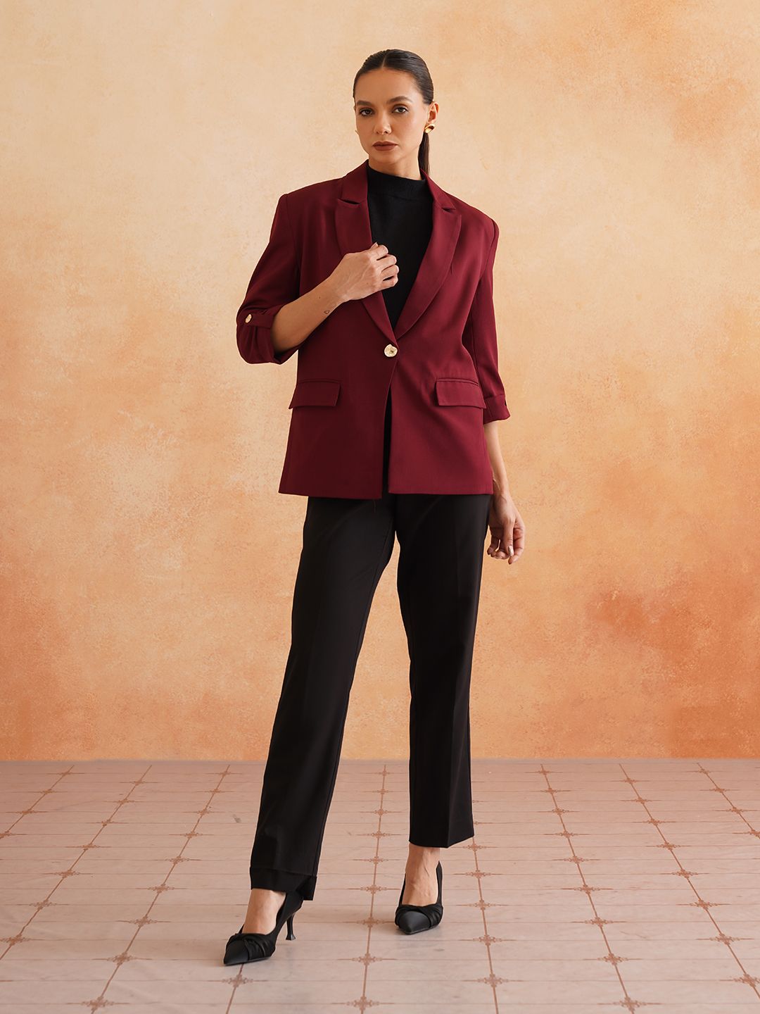 Woman in burgundy blazer with black outfit